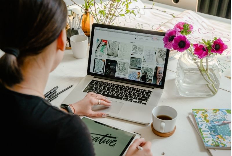 woman typing on laptop looking at Pinterest